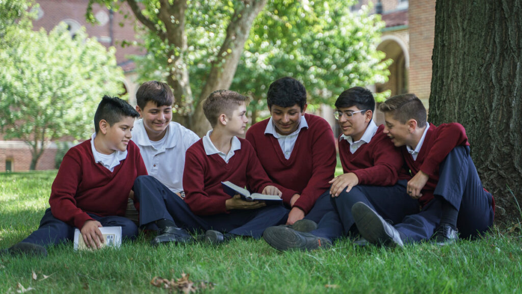 Sacred Heart Apostolic School Students help each other with their studies.